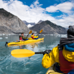 Friends kayaking in Bear Glacier, Alaska