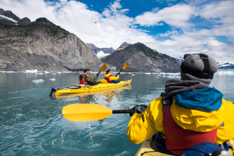 Friends kayaking in Bear Glacier, Alaska