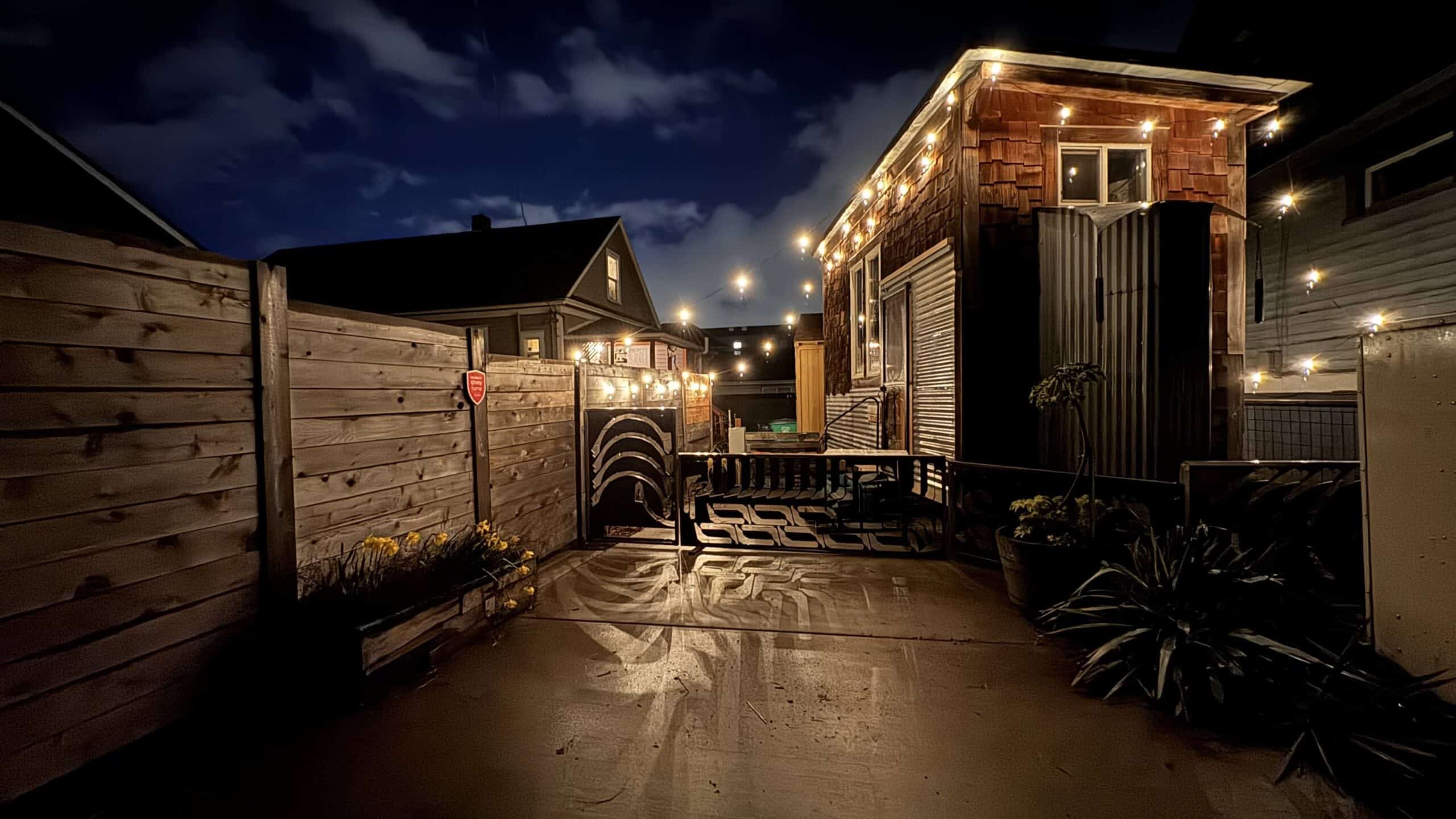 Photo of a mobile dwelling unit at night, with fairy lights